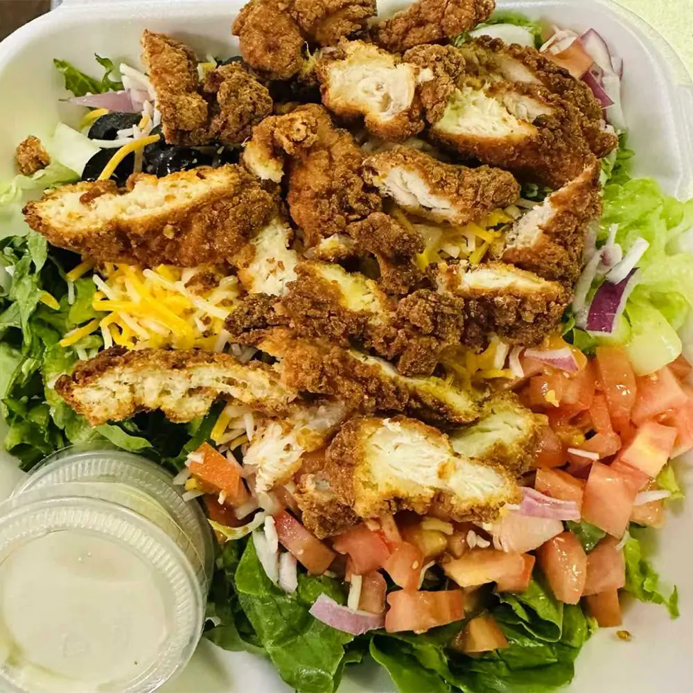 This is Crispy chicken salad, Crispy chicken, lettuce, tomato, onions, olives, shredded cheese